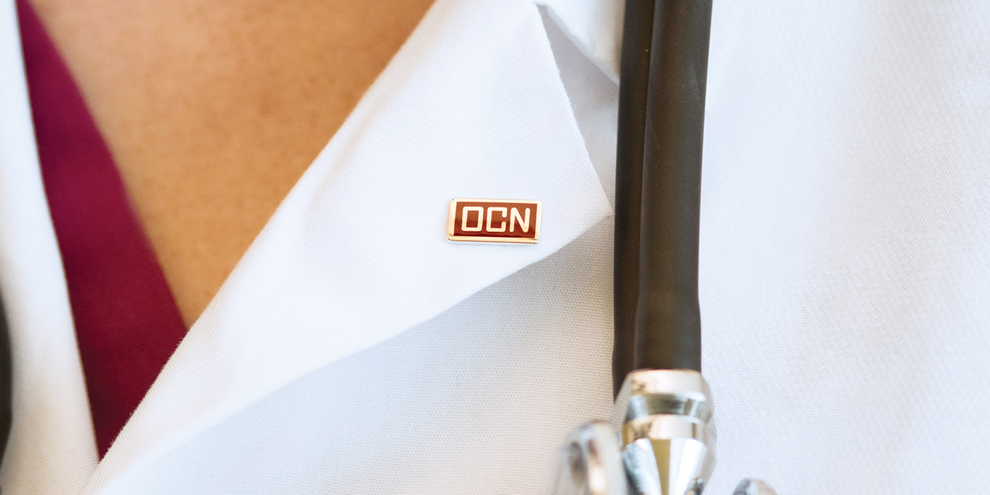 OCN pin on white coat